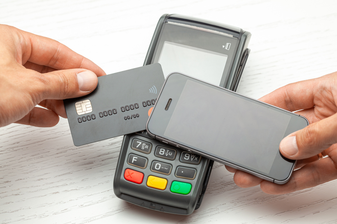 Contactless payment by credit card and smartphone phone. POS terminal NFC payment. Concept of how to choose payment method for shopping in a store.